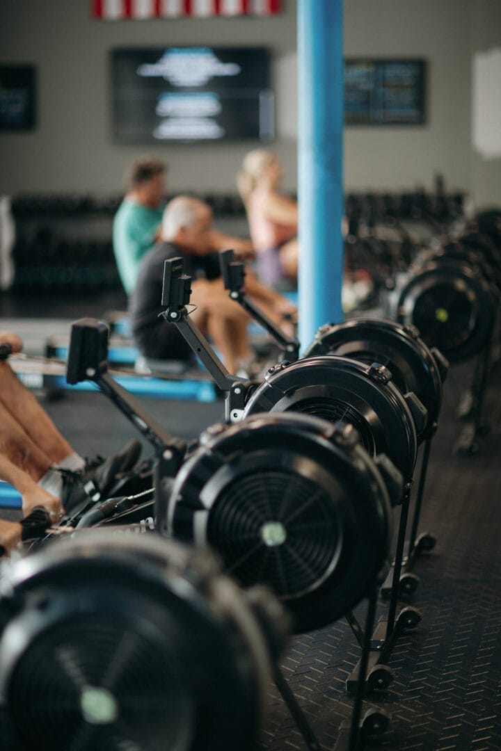 Barbells on a rack with an athlete training in the background