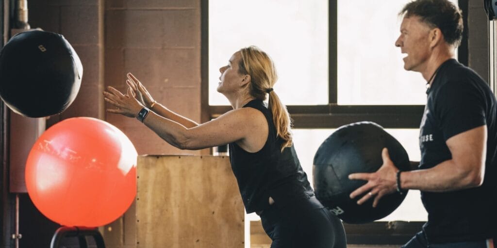 Athletes practicing medicine-ball throws, from the gym's website photo library